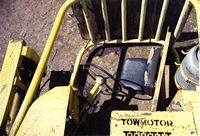 Overturned forklift - unsecured operator's seat.